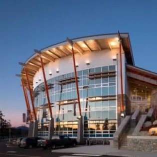 Half-crescent shaped, glass building.