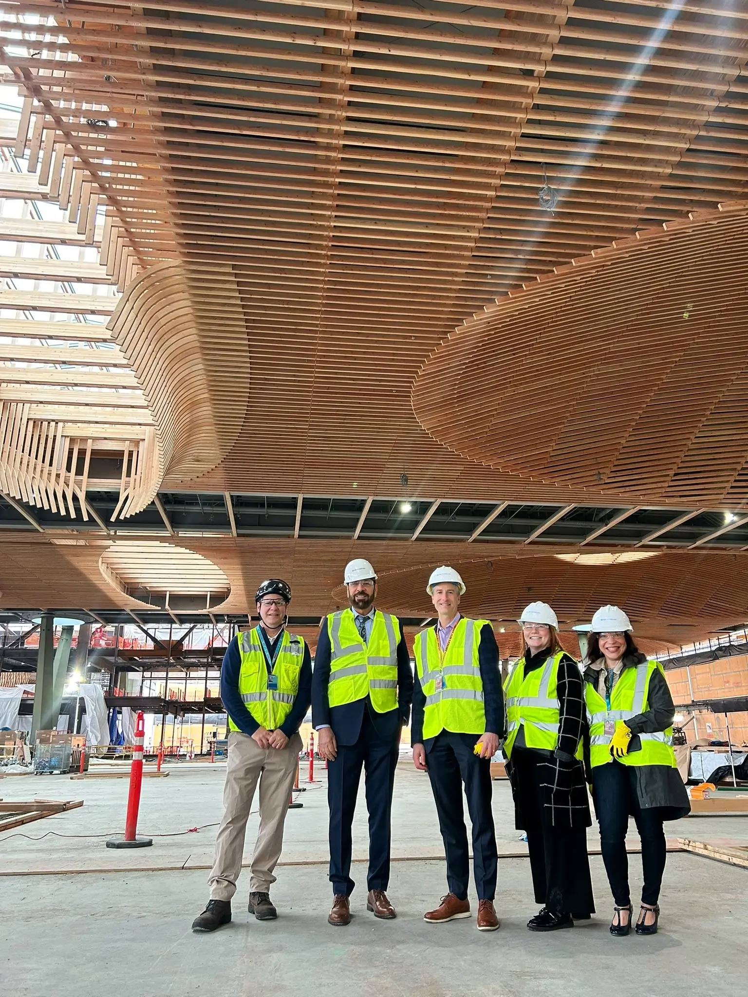 Minister Jagrup Brar is pictured with several colleagues at a new section of the Portland, OR airport that features mass timber construction