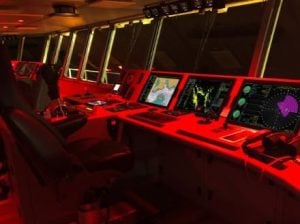 Navigation charting system shown inside a dark submarine.