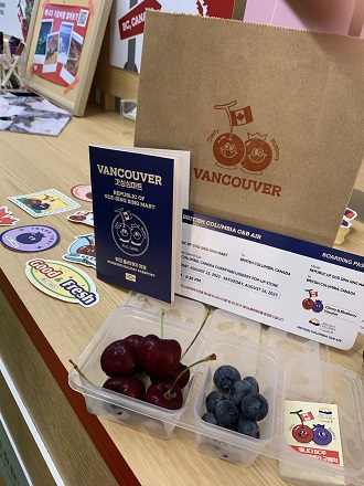 Contents of the samples at the pop-up: cherries, blueberries, fake passport to Vancouver, and brown bag.