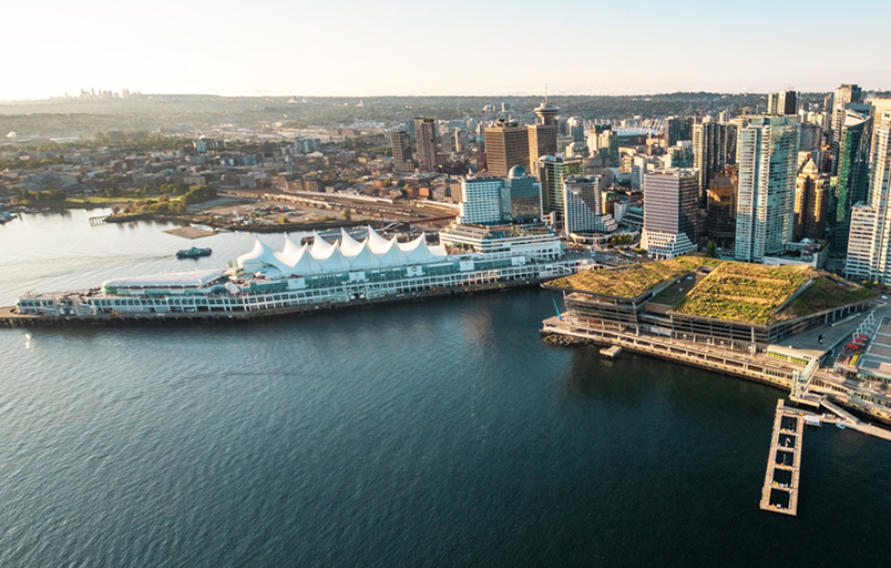 Aerial view of Vancouver’s waterfront in British Columbia, Canada, highlighting Canada Place, port infrastructure, and adjacent commercial buildings.