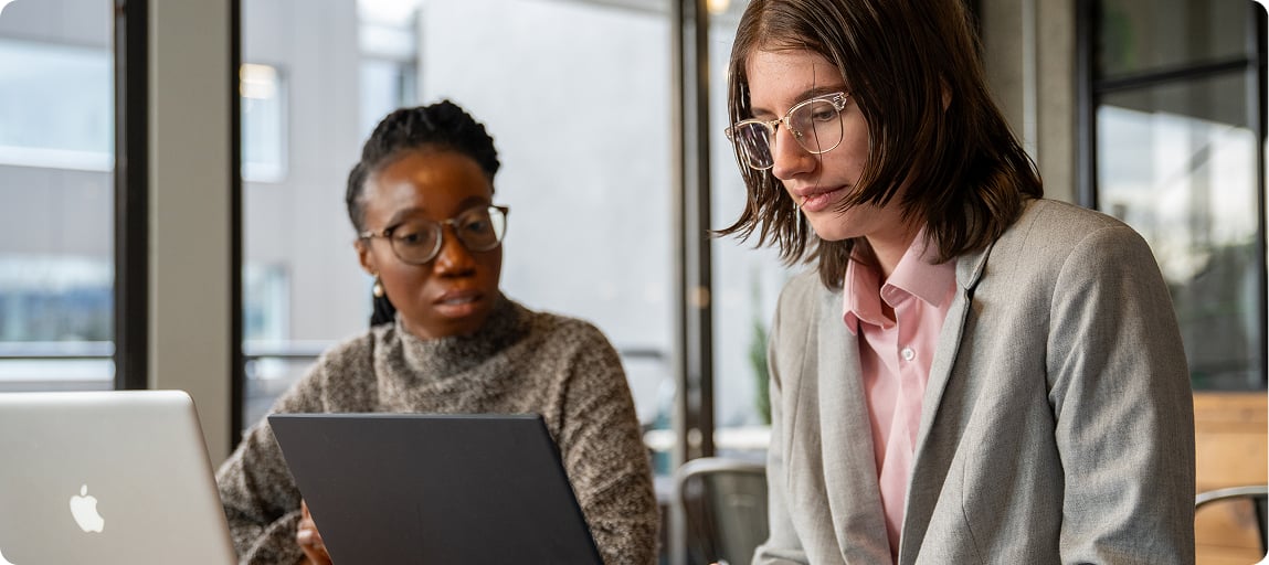 Diverse people working on laptop together in Cariboo