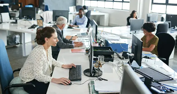 Employee working at desk with computers